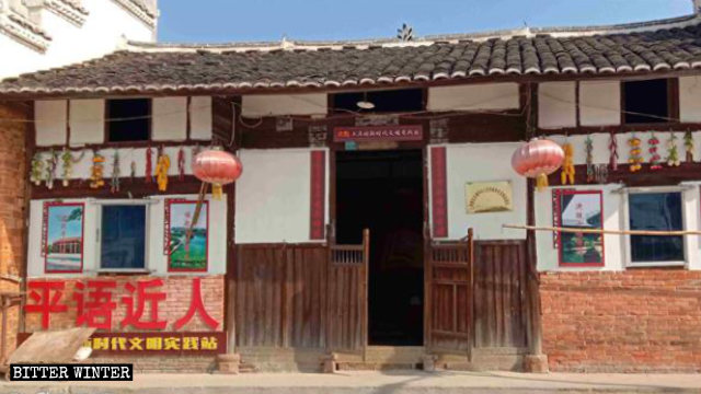 Letrero con la leyenda: "El idioma ping cercano al pueblo", colocado en la entrada de una “estación de prácticas civilizatorias para una nueva era” emplazada en la aldea de Shangzhuang.